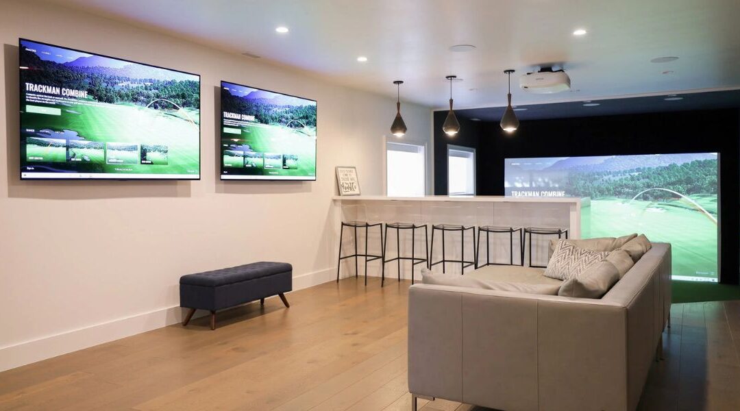 Luxury basement finishing from scratch in Herriman and Bluffdale UT featuring a large open-concept layout with a custom stone accent wall and modern media center.