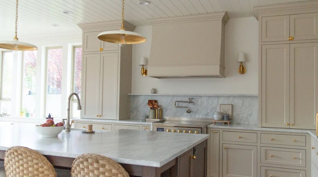 Luxury kitchen modernization and home remodeling in Herriman and Bluffdale UT featuring a waterfall quartz island, custom cabinets, and panel-ready appliances.