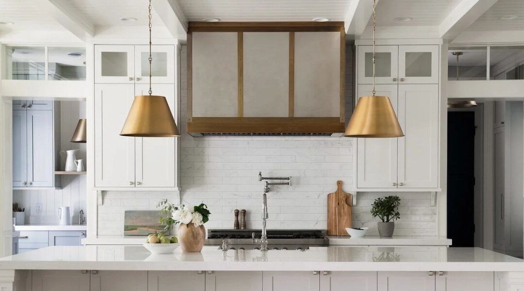 Luxury open gourmet kitchen remodel in Murray UT featuring a massive central quartz island with bar seating, custom wood cabinetry, and professional panel-ready appliances.