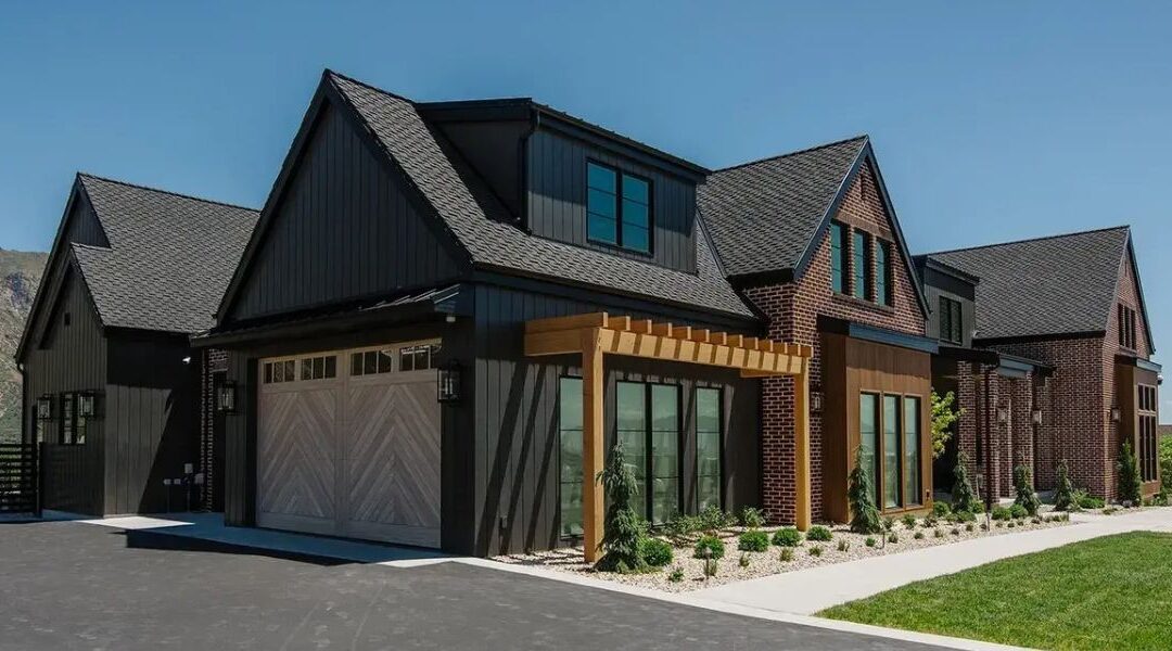Luxury home addition and great room extension in Riverton UT featuring high vaulted ceilings with exposed timber beams and large panoramic windows.