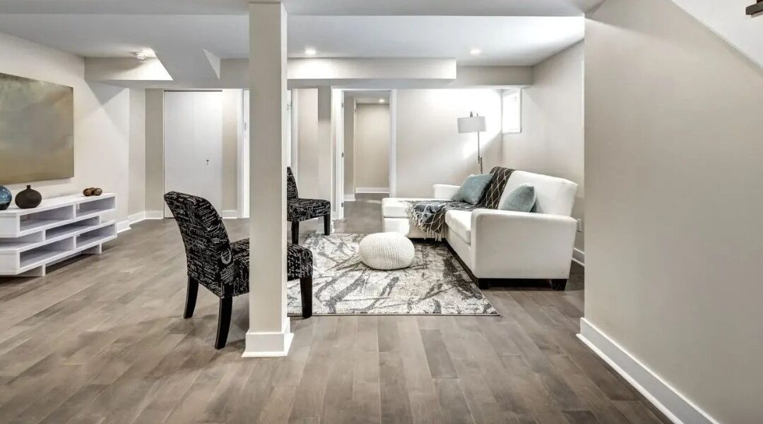 Luxury basement finishing in Sandy UT featuring a modern guest suite with a private bedroom, a sleek kitchenette, and large egress windows.