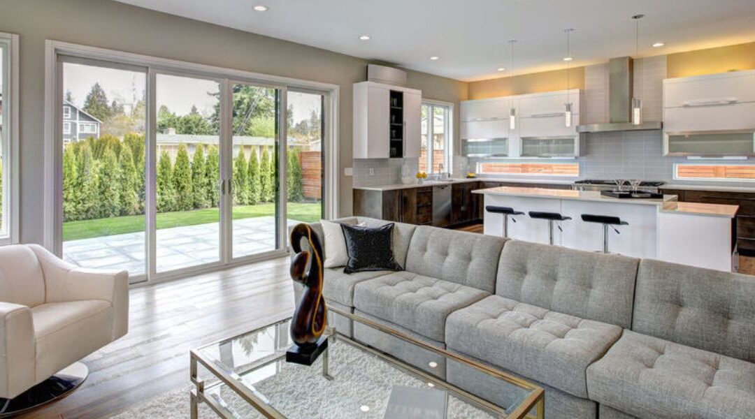 Luxury home addition in South Jordan UT showing a large master suite expansion with floor-to-ceiling multi-slide glass walls opening to a patio.
