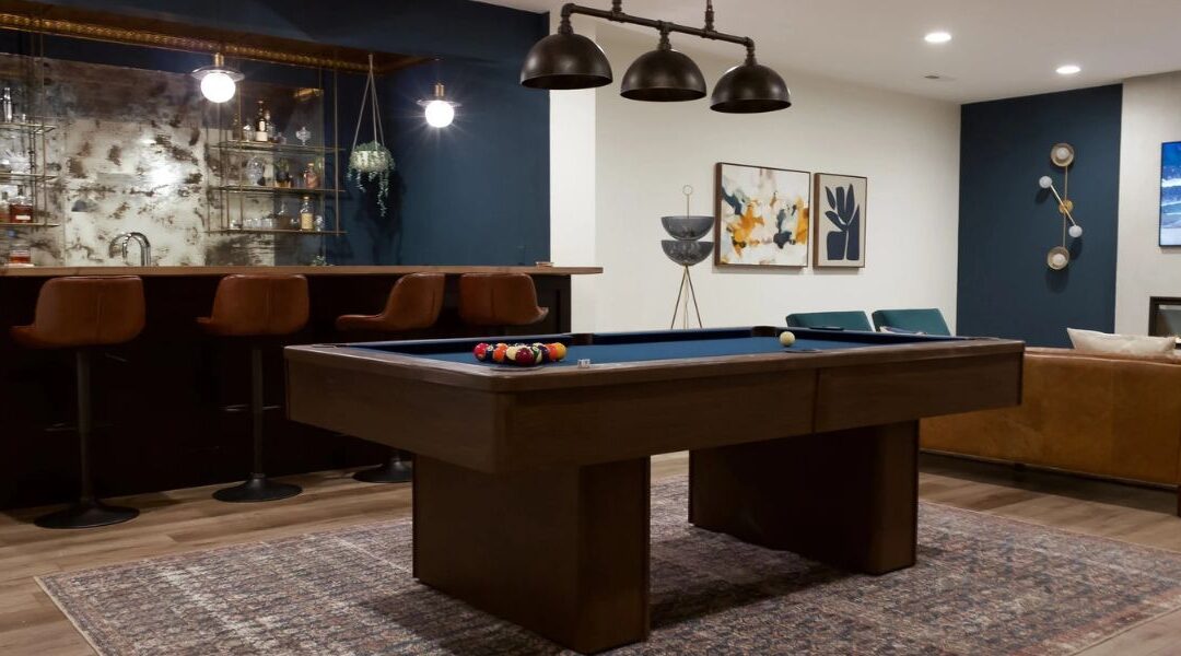 Luxury basement finishing in West Valley City UT featuring a custom walk-in wine tasting room, an executive wet bar, and a tier-seated home theater area.